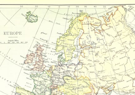 A paper map of Europe, with latitude and longitude lines.